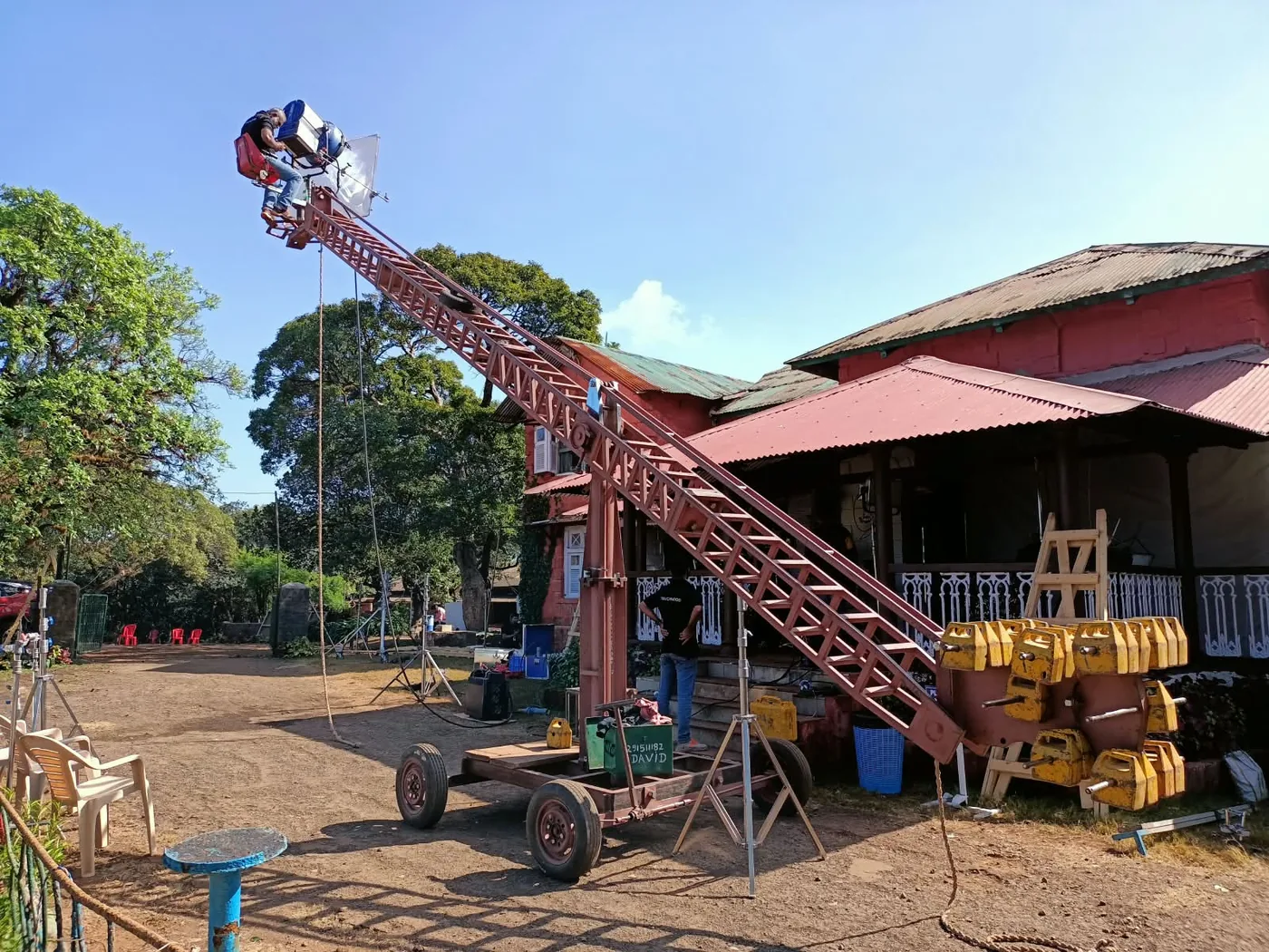 Jib arm rigged outside a colonial-era bungalow set